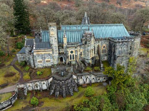 Aerial view of the enchanting St Conan's Kirk, a tapestry of grey stone and shimmering turquoise roof nestled amongst the autumn-toned trees, Lochawe, Scotland, United Kingdom.