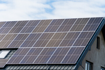 Numerous solar panels cover the rooftop of a residential home