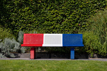 Colorful Red White and Blue Bench in Garden