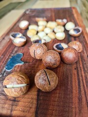 Macadamia nuts on the wood background