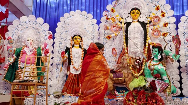 hindu devotees offering prayers to durga idol during dussehra in daylight