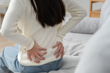 woman holding back while and suffer from unbearable pain health and problems, chronic back pain,...
