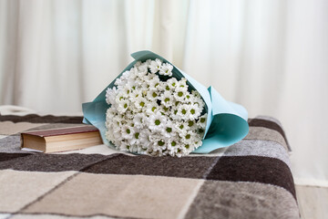 Romantic composition with flowers and book for cozy home atmosphere. A beautiful bouquet of fresh...