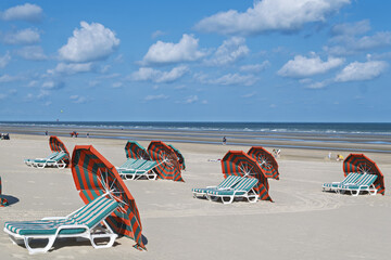 Beach chairs and umbrellas, to shelter from the wind, are the typical beach equipment of the...