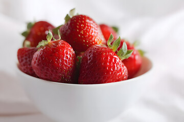 Bowl of fresh red strawberries on white background, perfect for healthy food and dessert designs.