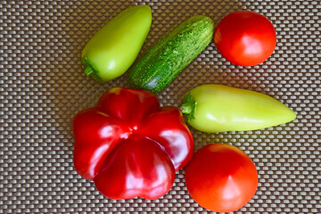 Set of fresh vegetables on the table, Ingredients:  tomatoes, cucumber, sweet peppers and zucchini....
