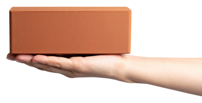 side view of hand carrying a red brick isolated on white background