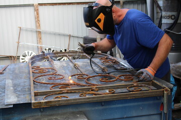 man at home working with metal and welding