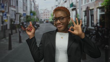 Young african american woman making ok sign with hand near bike parking on sunlit urban city...