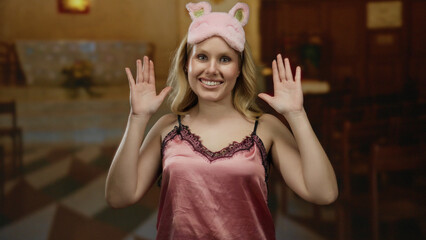 Young woman in nightwear playfully covering face with hands in a catholic church setting, capturing...