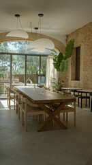 Elegant mediterranean restaurant interior with wooden table, glass walls, modern lighting, stone walls, lush plant, and scenic outdoor view embracing natural sunlight and warmth.