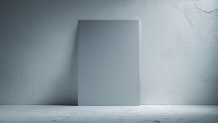 A blank white canvas or panel placed against a textured wall in a minimalistic setting.