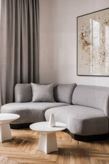 Contemporary living room with curved sofa, sculptural coffee table, and textured wall art for modern design inspiration