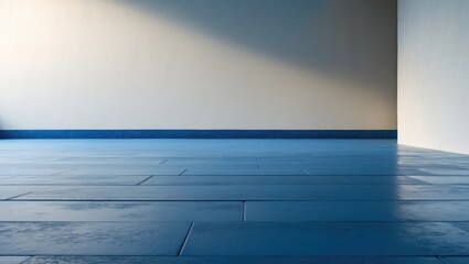 Empty blue tiled floor with a corner wall and sunlight, minimal interior space, modern design.