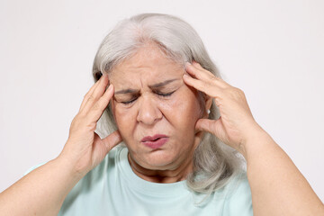 Close of senior woman suffering painful headache 
on white studio background