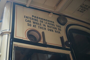 Crich Tramway Museum, England - August 13 2025: Close-up of old warning sign inside vintage tramcar