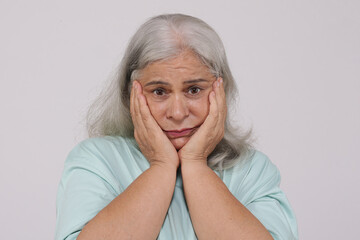 Indian sad and depressed senior old woman 
isolated on white background