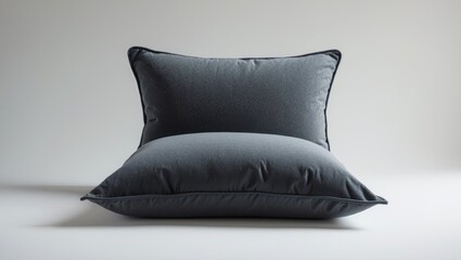 Gray pillows stacked, with a pillow on top of another pillow. Simple bedroom decor, comfort, and cozy textiles. Home interior, bedroom accessories, and soft furnishings.