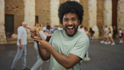 Man pointing excitedly outdoors with blurred crowd background highlighting lively city atmosphere...