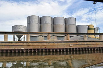 Modern Industrial Facility with Storage Silos River Bank 