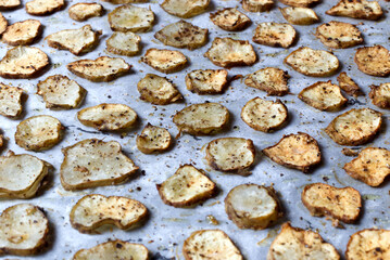 Baked Root of Jerusalem artichokes Vegetable Chips on Parchment Paper