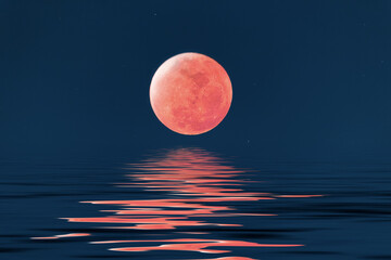 Super blue blood full moon over cold night water.