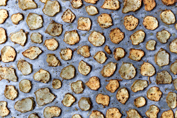 Baked Root of Jerusalem artichokes Vegetable Chips on Parchment Paper