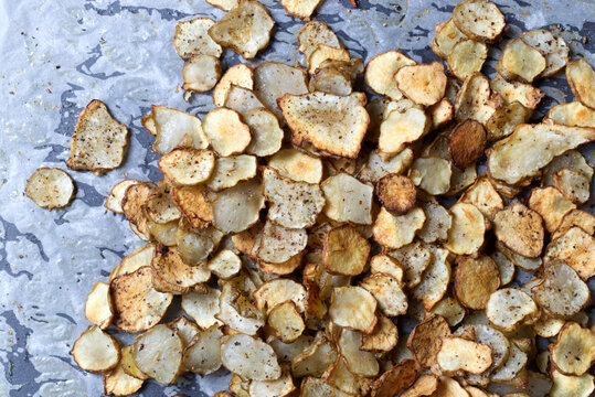 Baked Root of Jerusalem artichokes Vegetable Chips on Parchment Paper
