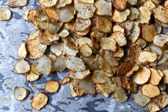 Baked Root of Jerusalem artichokes Vegetable Chips on Parchment Paper
