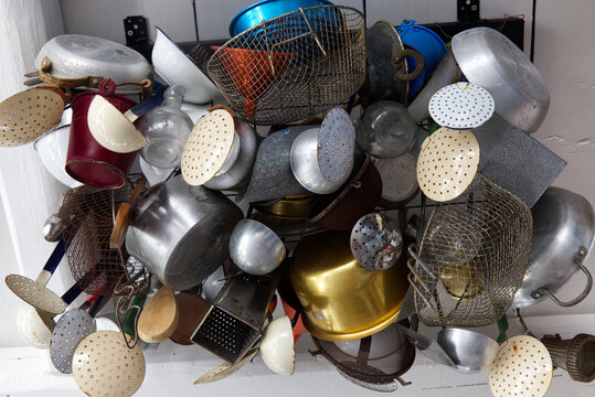 Assortment of Kitchen Utensils Displayed on a Wall with Varied Colors
