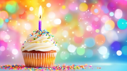 A single birthday cupcake with a lit candle on a colorful background.