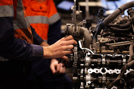 Male mechanics hand working on mining fleet vehicles engine
