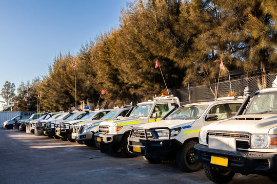 Fleet of white utility vehicles lined up outside service hub