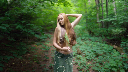 Enchanting young woman in the forest.