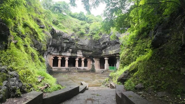 Majestic Exterior of Elephanta Caves with Massive Columns in Monsoon Greenery