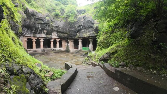 Majestic Exterior of Elephanta Caves with Massive Columns in Monsoon Greenery