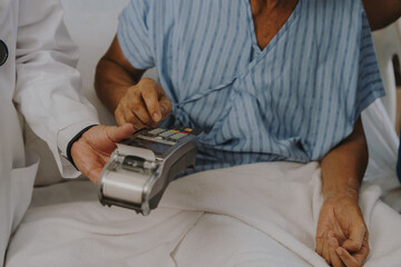 Patients are using money and credit cards to pay for medical services after successful treatment.