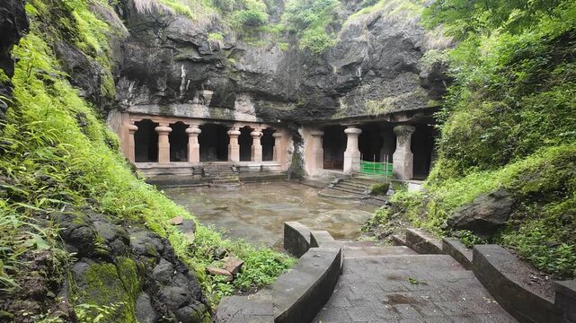 Majestic Exterior of Elephanta Caves with Massive Columns in Monsoon Greenery