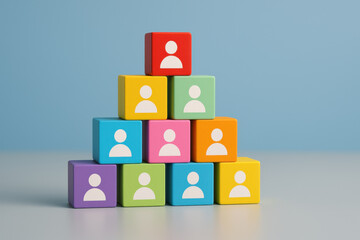 Colorful wooden blocks stacked in pyramid shape with user icons symbolizing team hierarchy and collaboration on blue background