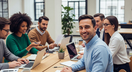 Group of multiethnic business people in a modern office, collaborating on a project. The focus is on teamwork and a positive corporate environment
