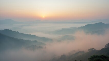 Obraz premium Sunrise over misty mountains with clouds and fog obscuring the landscape. Nature and sunrise scene. Scenic and peaceful view of the mountains.