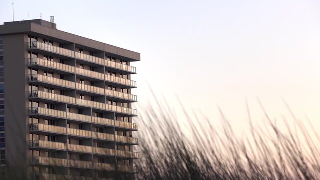 Establishing shot of ocean side apartment complex at sunset 4k