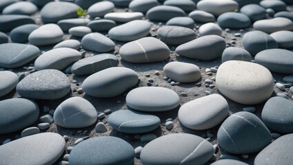 Obraz premium Collection of smooth stones on the ground, with a variety of shapes and shades. Natural outdoor scene with pebbles of different sizes and colors.