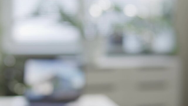 Hand of real estate agent handing over house keys to homeowner after successful deal in office. Close-up view