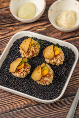 Gourmet quinoa balls with crispy texture and artistic garnish
