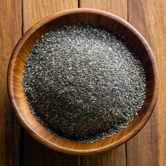 A wooden bowl brimming with chia seeds sits on a rustic wooden surface