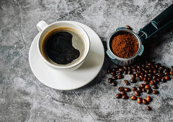 Aromatic Coffee cup and beans with ground coffee on Portafilter, Espresso coffee cup aromatic and making equipment