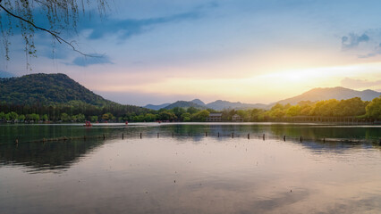 Scenic lake with mountains under colorful sunset sky