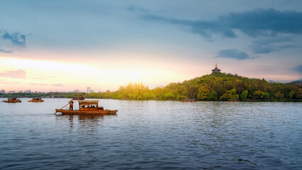 Scenic West Lake with Traditional Boats at Sunset