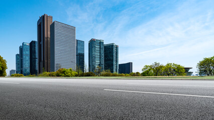 Modern urban business district with tall glass buildings under blue sky
